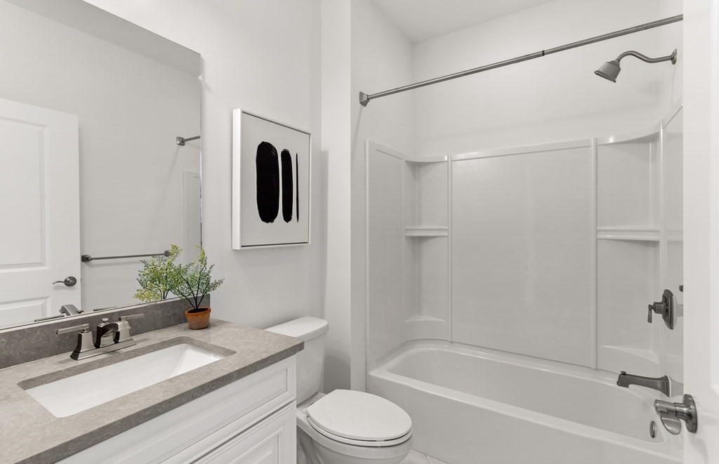 57 Sienna Circle, Unit 44 Upton, MA 01568 - Photo 9 of 21 a bathroom with a granite countertop sink toilet and shower