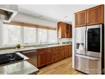 a kitchen with stainless steel appliances granite countertop a stove and a sink