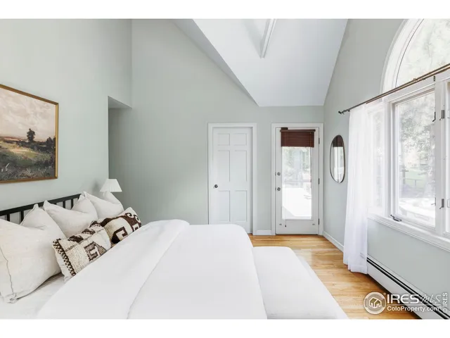 a bed room with two bed and a window