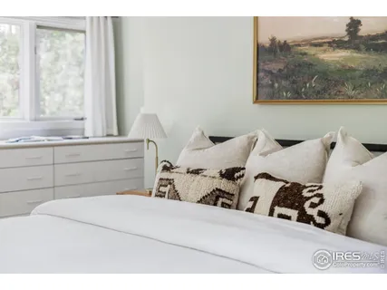 a spacious bedroom with a large bed and a window