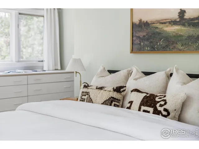 a spacious bedroom with a large bed and a window