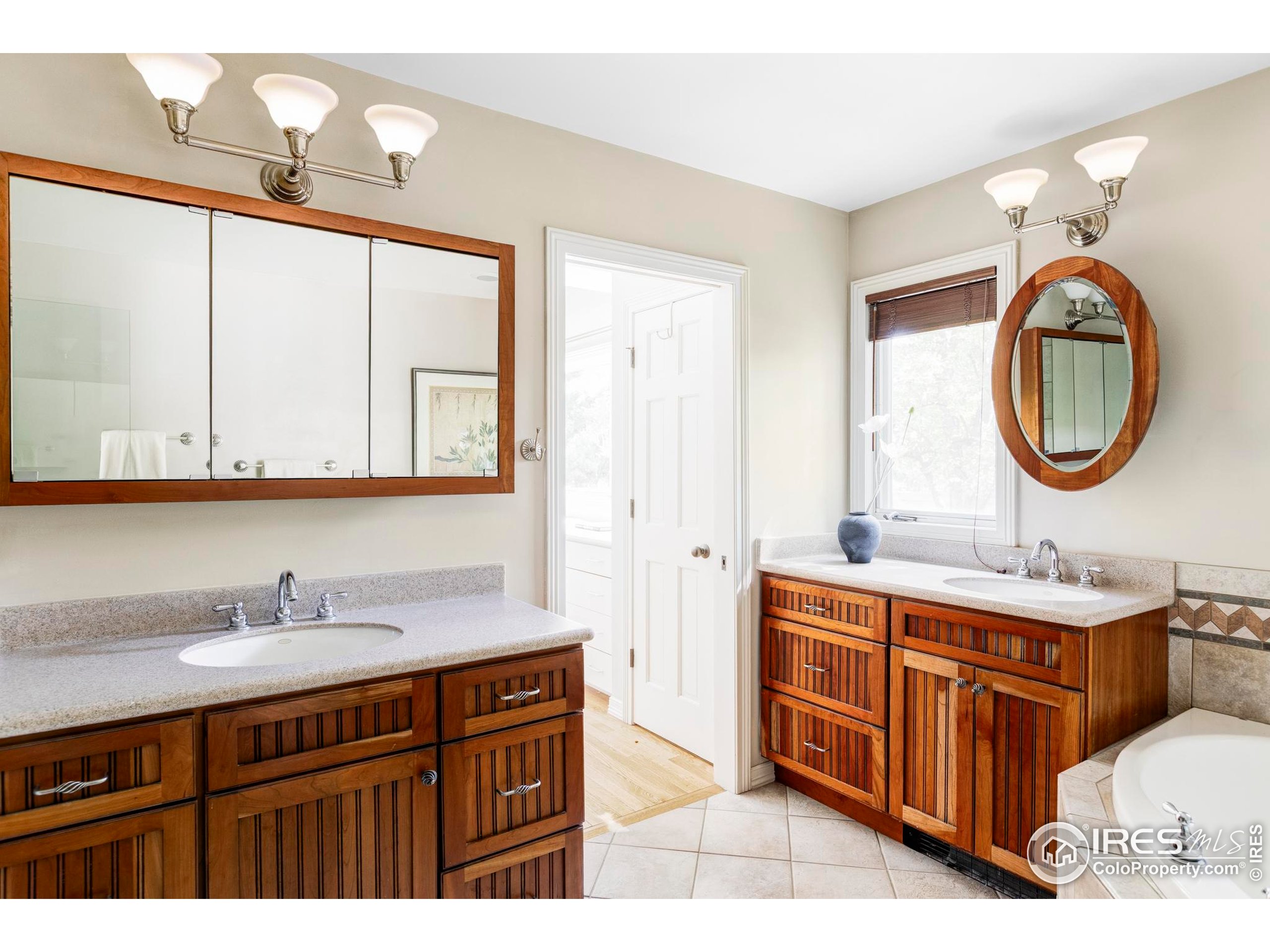 2672 Winding Trail Drive Boulder, CO 80304 - Photo 25 of 31 a bathroom with a sink and a mirror