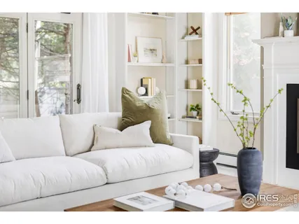 a living room with furniture a rug and a fireplace