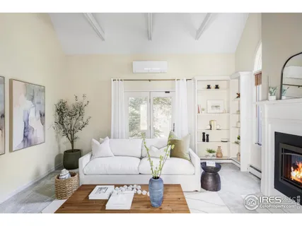 a living room with furniture a fireplace and a window