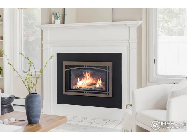 a living room with furniture a window and a fireplace