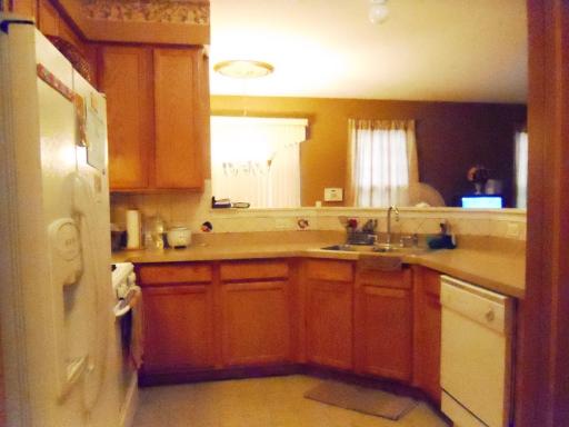 1966 Crestview Circle, Unit 1966 Romeoville, IL 60446 - Photo 2 of 7 a kitchen with a sink a window and cabinets