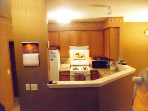 1966 Crestview Circle, Unit 1966 Romeoville, IL 60446 - Photo 3 of 7 a kitchen with a sink a stove and a refrigerator