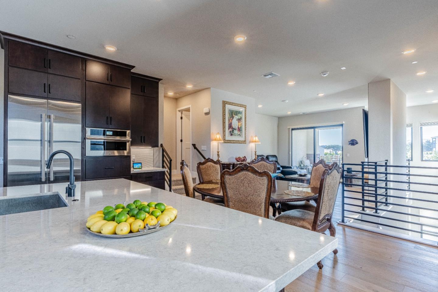 135 8th Street Marina, CA 93933 - Photo 32 of 69 an open kitchen with dining table and wooden cabinets