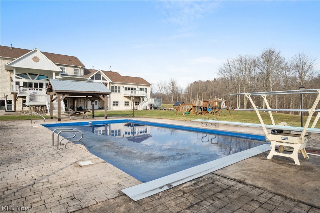 9419 Robinson Road Chardon, OH 44024 - Photo 43 of 46 Outdoor pool with a playground, a patio, a diving board, a yard, and a gazebo