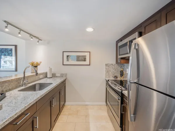 a kitchen with a refrigerator sink and stove