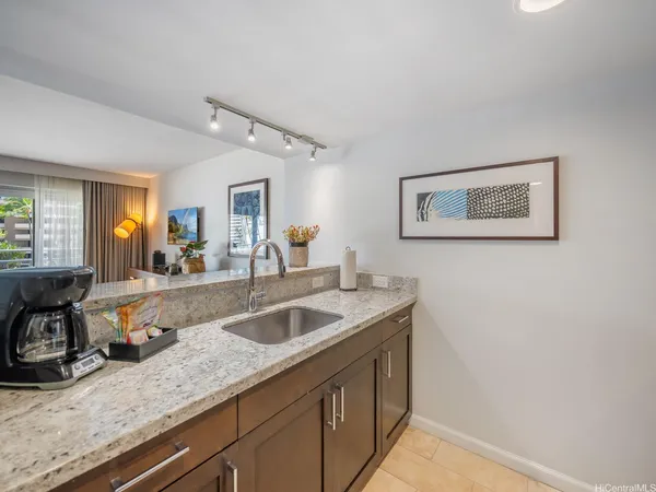 a kitchen with a sink and a refrigerator