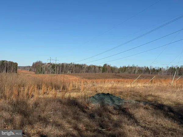 a view of lake with green landscape