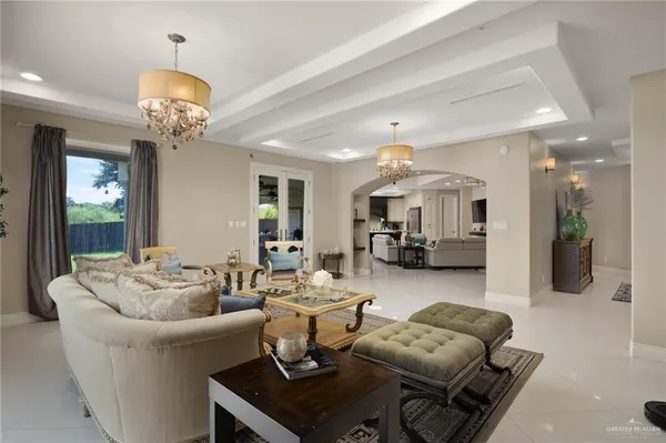 a living room with furniture and a chandelier