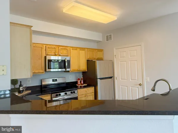 a kitchen with a refrigerator a stove a sink and a microwave