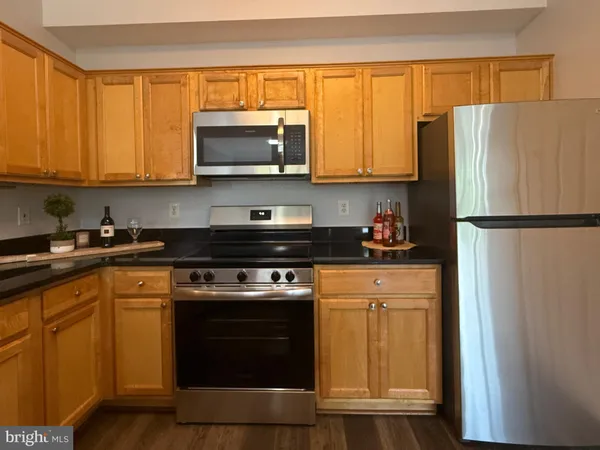 a kitchen with a refrigerator stove and microwave