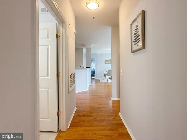 a view of a hallway with wooden floor