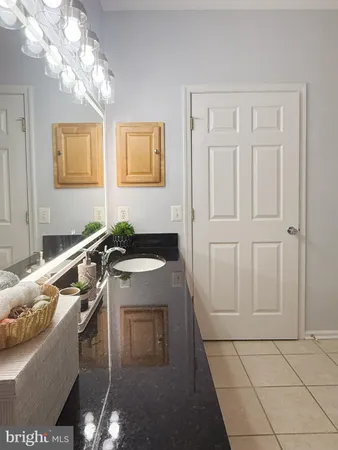 a bathroom with a granite countertop sink a washer and dryer