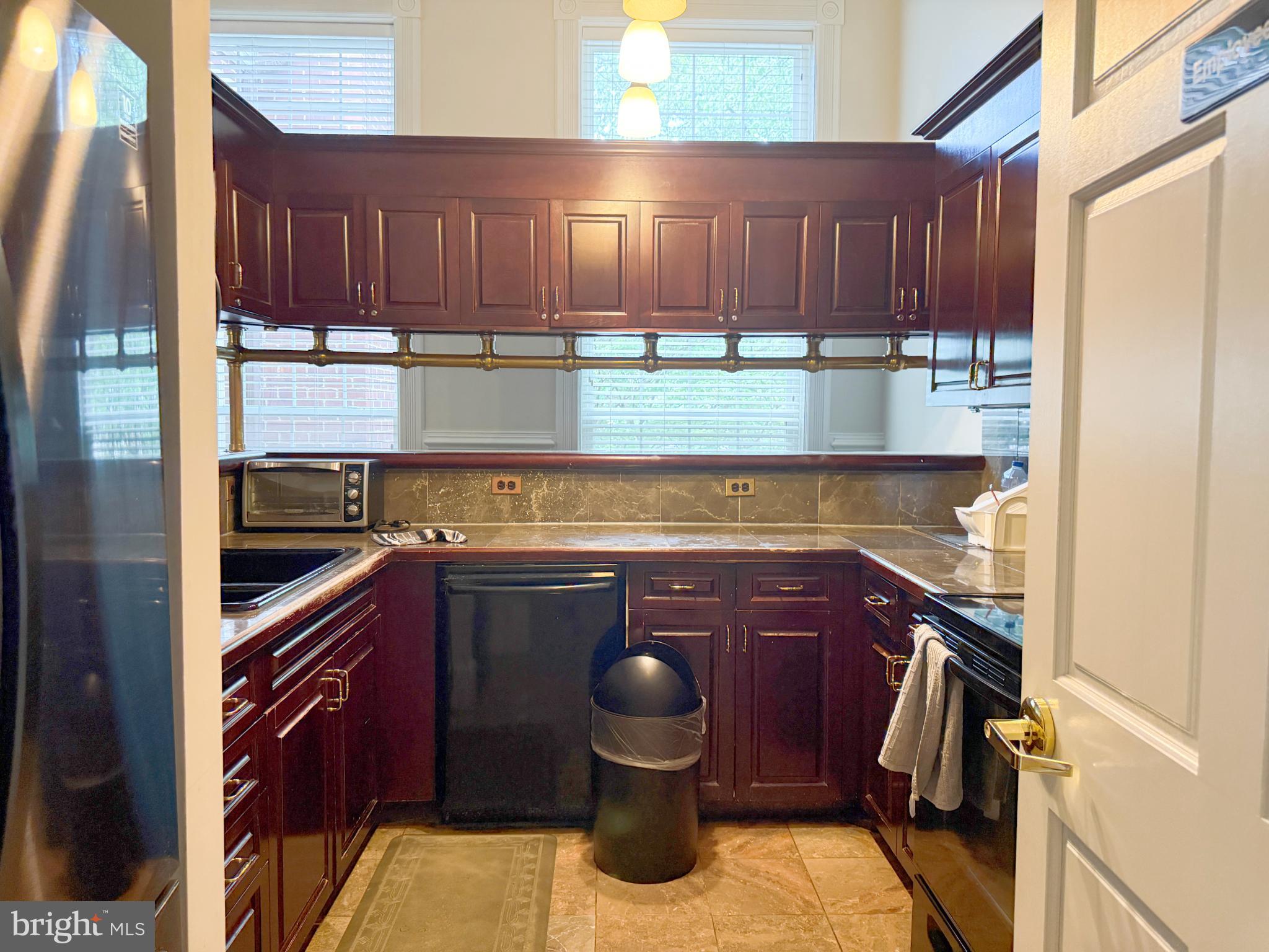 1530 Spring Gate Dr., Unit 9317 McLean, VA 22102 - Photo 47 of 55 Charming kitchen with rich wood cabinetry.