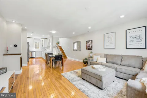 a living room with furniture and kitchen view