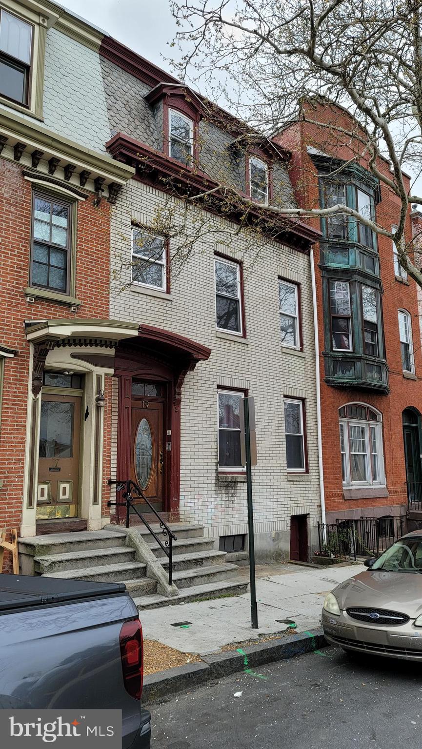 a view of a building with car parked