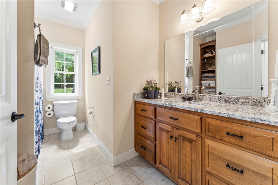 160 Sentell Road Williamston, SC 29697 - Photo 28 of 45 Dual vanities with granite counters complement the tiled flooring in this bright bathroom.