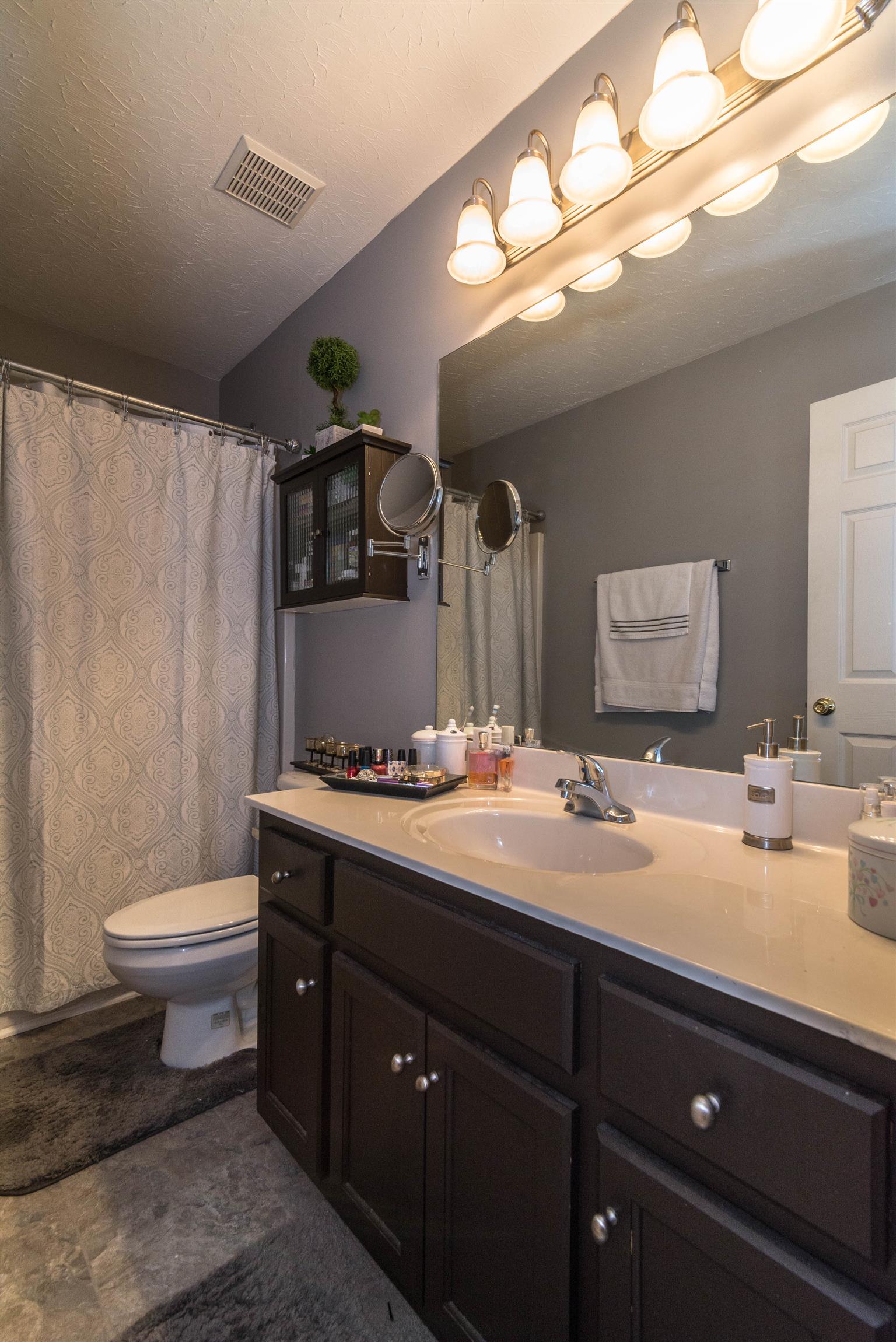 1355 Cedar Grove Road Lebanon, TN 37087 - Photo 10 of 12 a bathroom with a toilet sink double vanity and mirror
