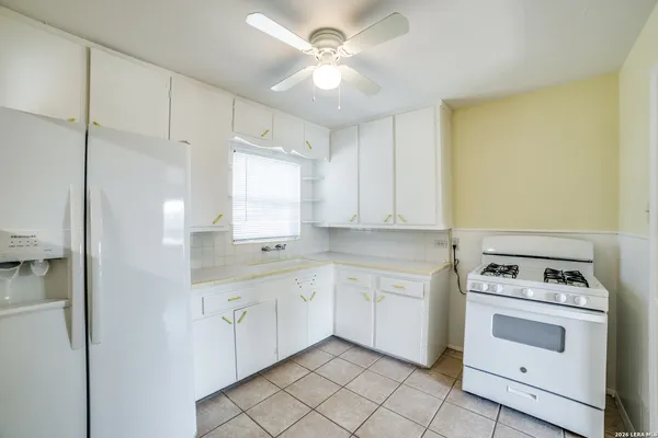 a kitchen with a stove sink and cabinets