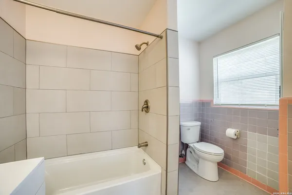 a bathroom with a bathtub and a toilet