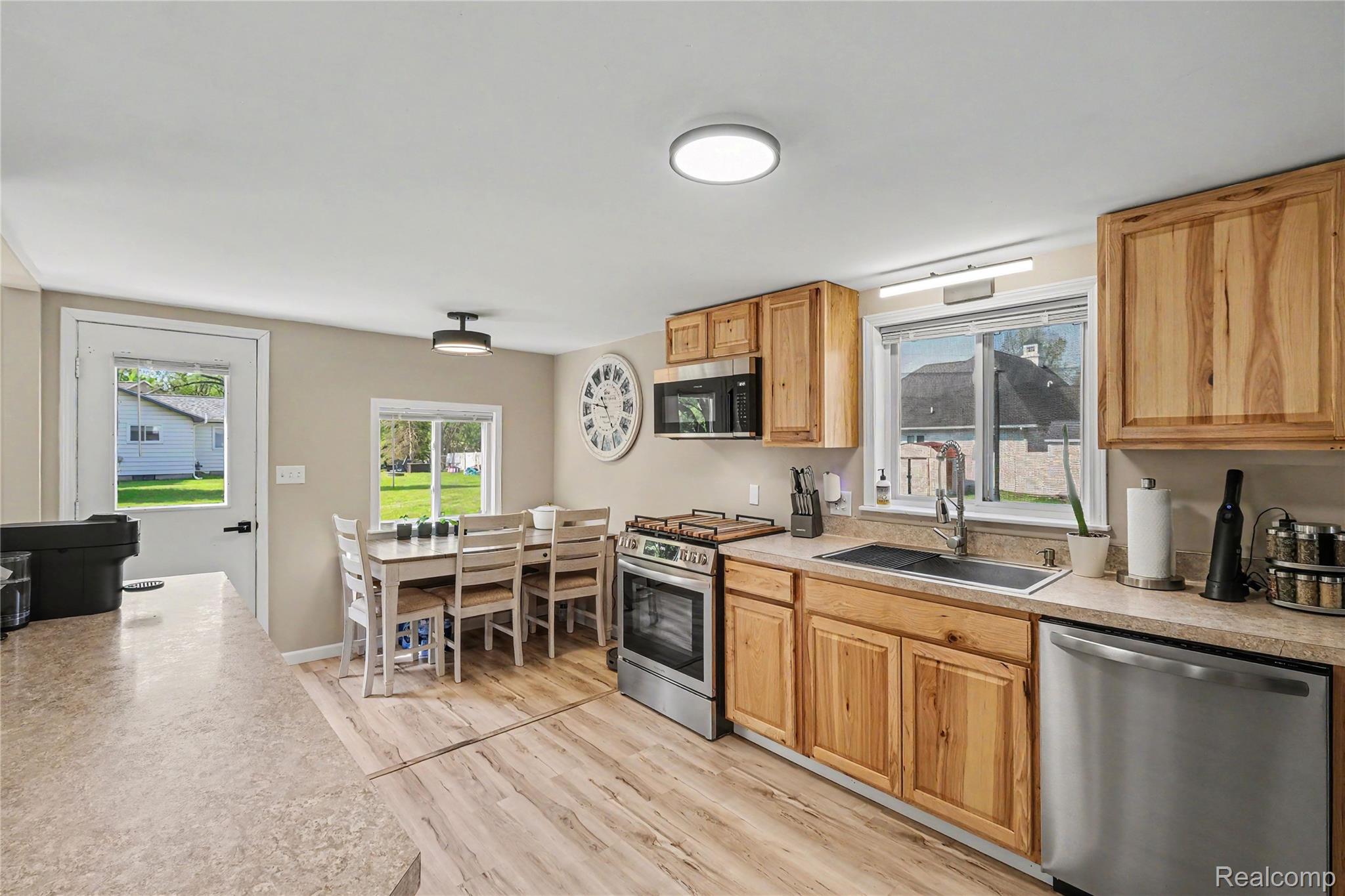 306 Mill Street Pinckney, MI 48169 - Photo 8 of 29 Kitchen feataures new stainless steel appliances and gas stove