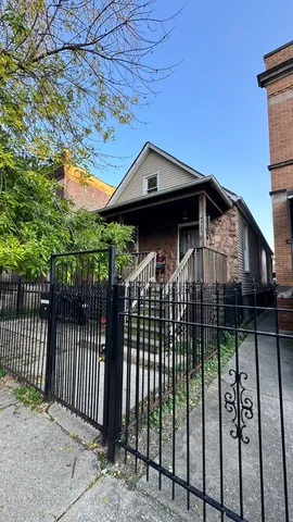 a front view of a house with wooden fence