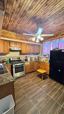 a kitchen with a sink appliances and cabinets