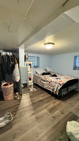 a bedroom with a bed and a chair