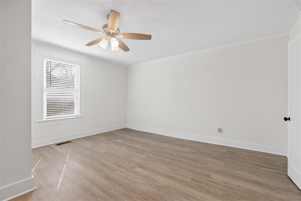 246 Spring Street Commerce, GA 30529 - Photo 13 of 23 wooden floor in an empty room with a window