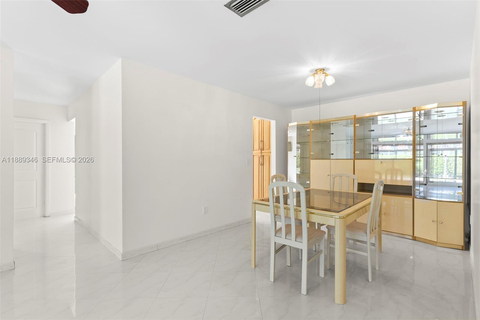 300 93rd Street Surfside, FL 33154 - Photo 13 of 34 a dining room with furniture and a floor to ceiling window