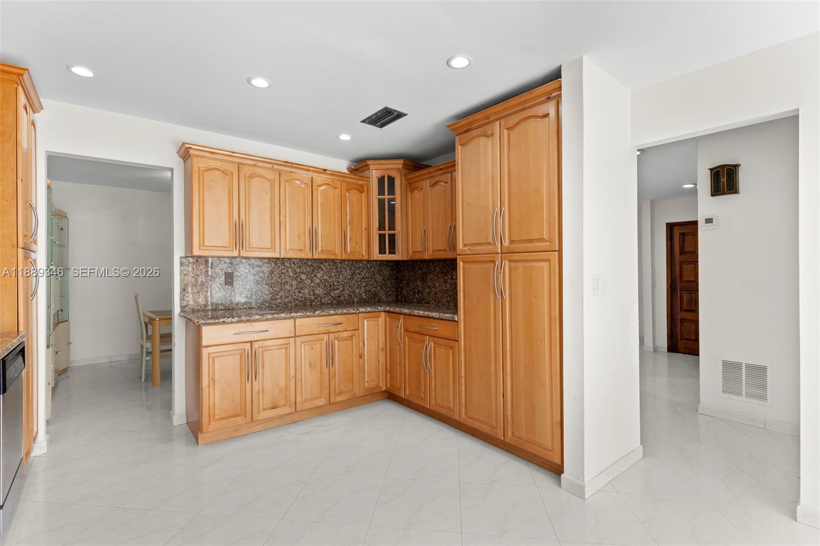 300 93rd Street Surfside, FL 33154 - Photo 17 of 34 a kitchen with granite countertop stainless steel appliances a refrigerator and cabinets