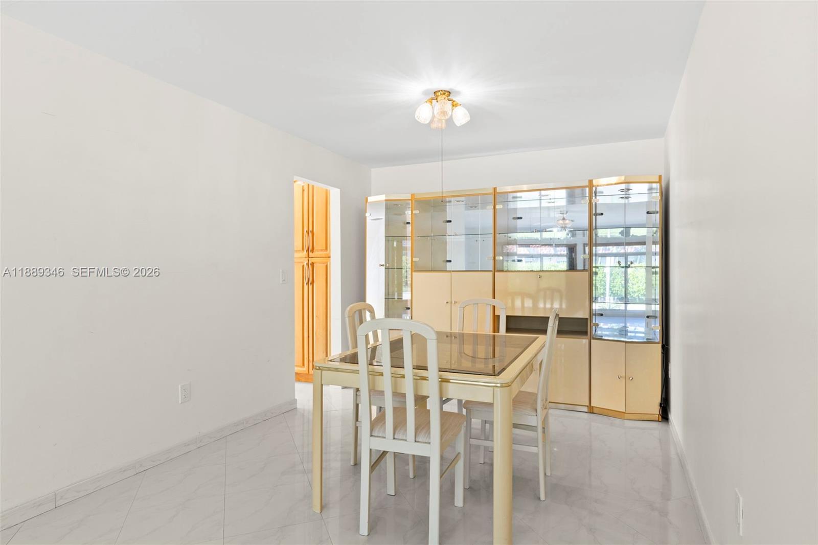 300 93rd Street Surfside, FL 33154 - Photo 21 of 34 a view of a dining room with furniture and a window