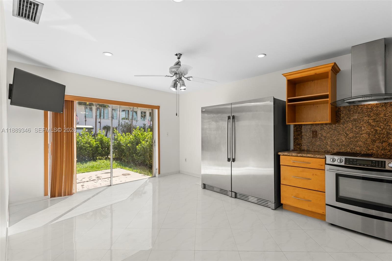 300 93rd Street Surfside, FL 33154 - Photo 22 of 34 a open kitchen with stainless steel appliances granite countertop a refrigerator and a sink
