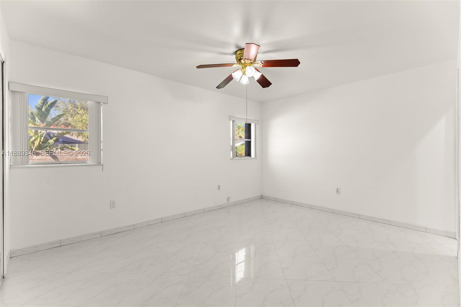 300 93rd Street Surfside, FL 33154 - Photo 24 of 34 an empty room with a window and a fan