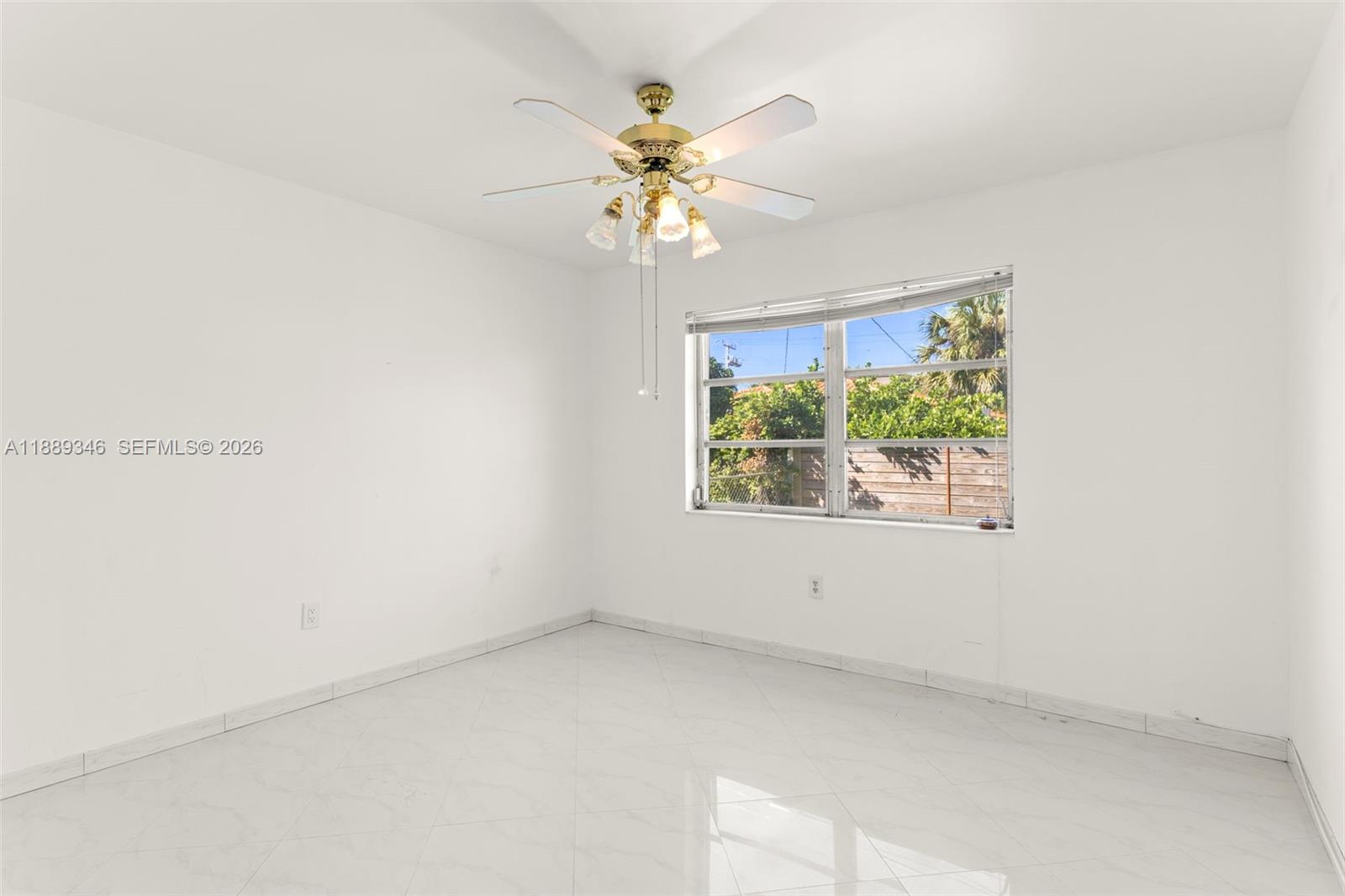 300 93rd Street Surfside, FL 33154 - Photo 28 of 34 an empty room with window and a ceiling fan