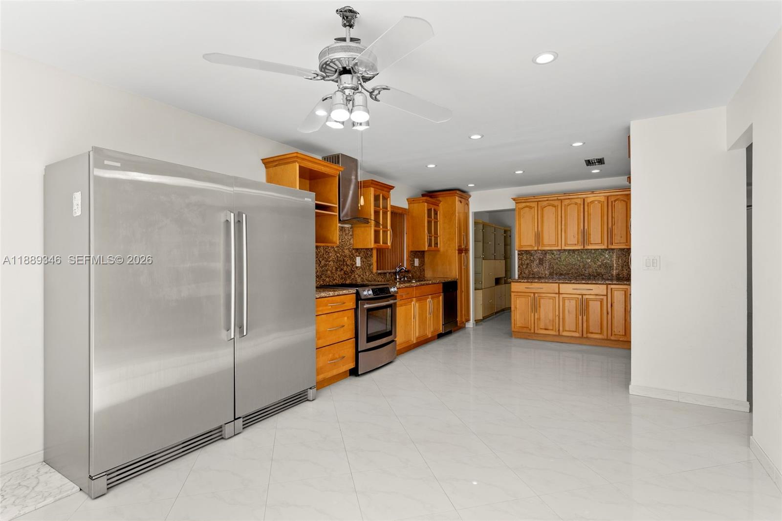 300 93rd Street Surfside, FL 33154 - Photo 3 of 34 a view of a kitchen with a refrigerator and a stove top oven