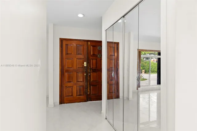 a view of a hallway with wooden walls