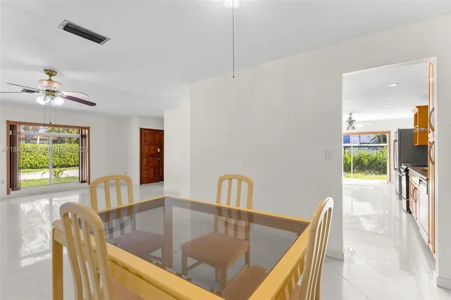 a view of a house with pool and sitting area