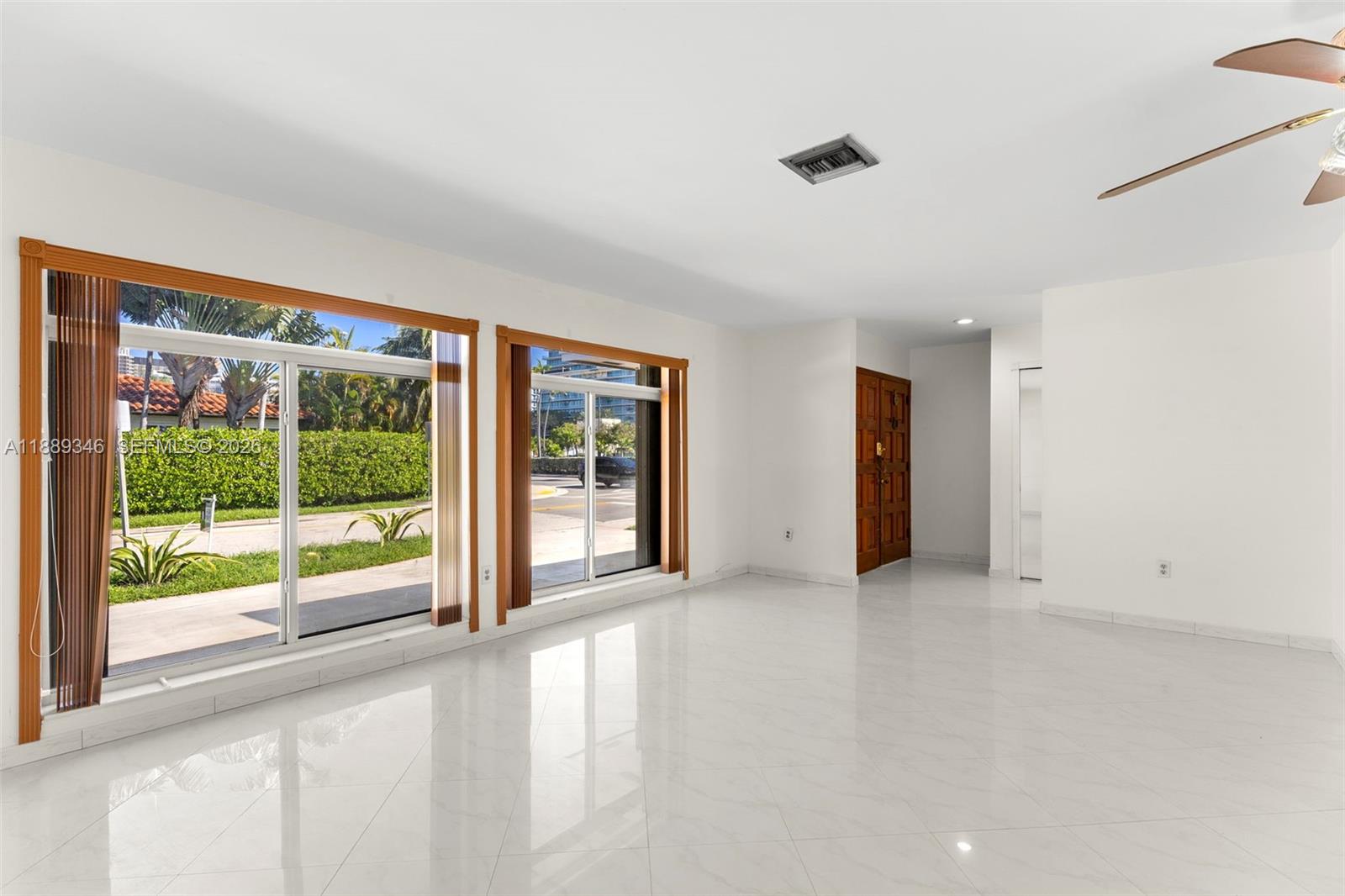 300 93rd Street Surfside, FL 33154 - Photo 9 of 34 a view of an empty room with a sliding door