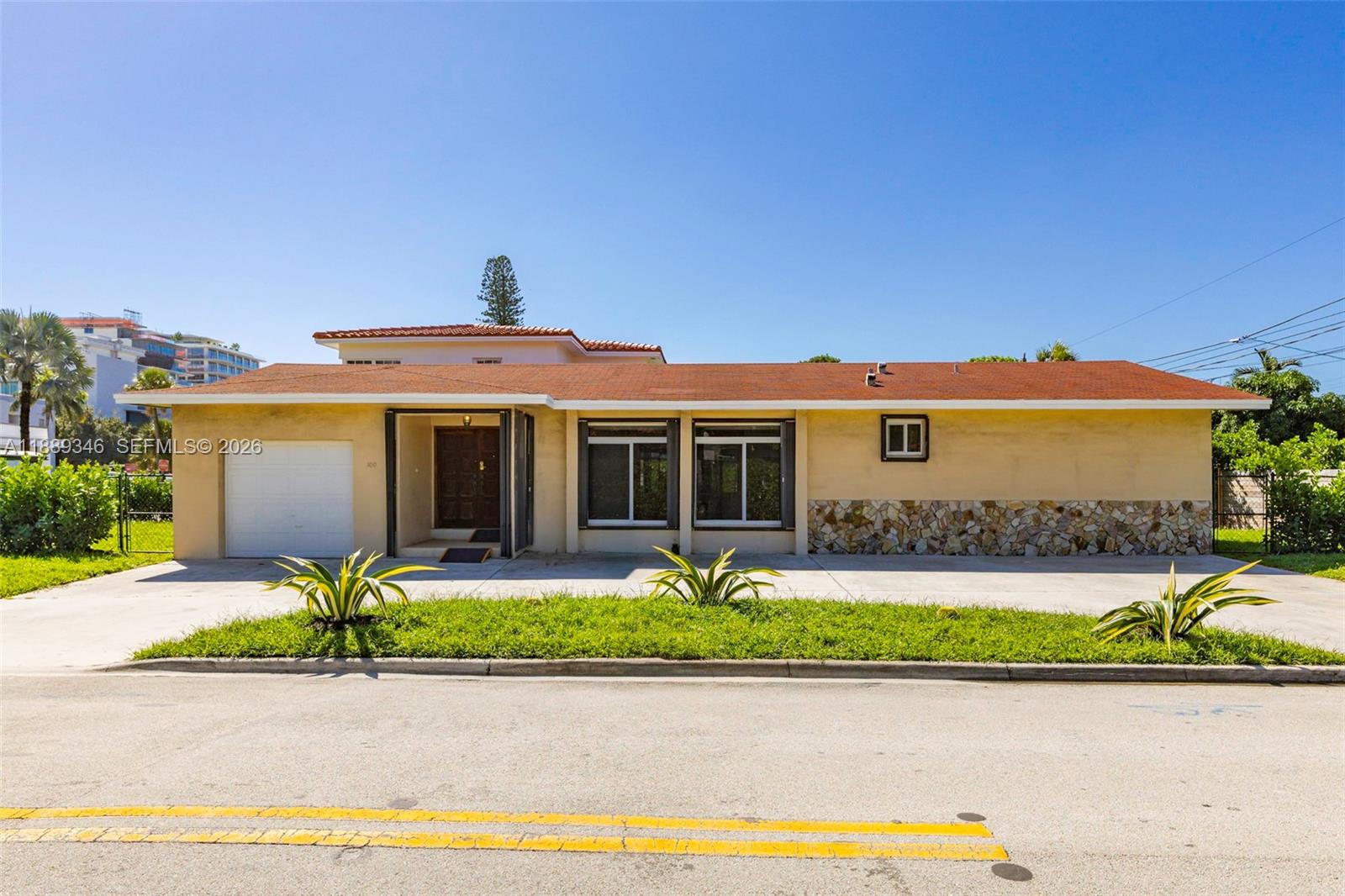 300 93rd Street Surfside, FL 33154 - Photo 10 of 34 front view of a house with a yard