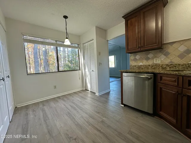 a bedroom with a bed wooden floor and lamp