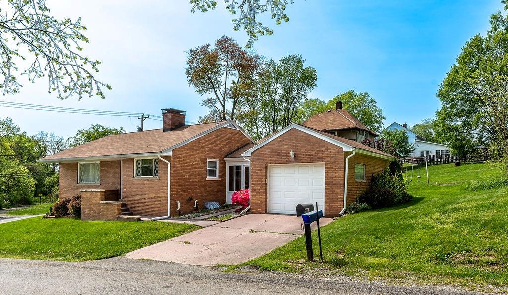 767 Virginia Avenue Rochester, PA 15074 - Photo 2 of 16 a front view of a house with a garden and yard