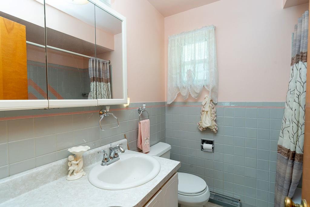 767 Virginia Avenue Rochester, PA 15074 - Photo 9 of 16 a bathroom with a sink toilet and a mirror