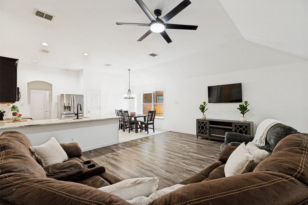 4305 Ridgewood Road Melissa, TX 75454 - Photo 7 of 26 Expansive living area featuring wood-finish flooring and a contemporary ceiling fan