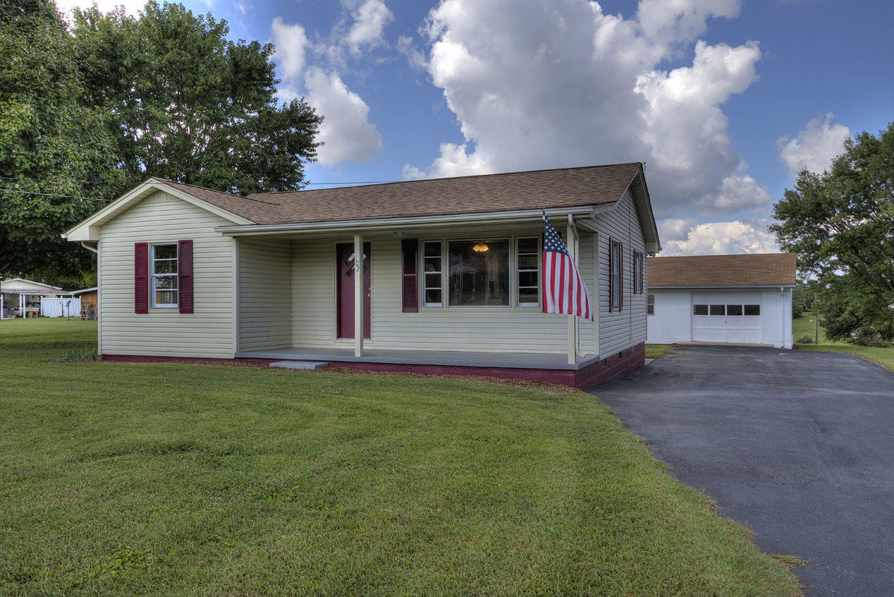 102 Stephens Road Greenback, TN 37742 - Photo 1 of 31 a front view of a house with a garden and yard