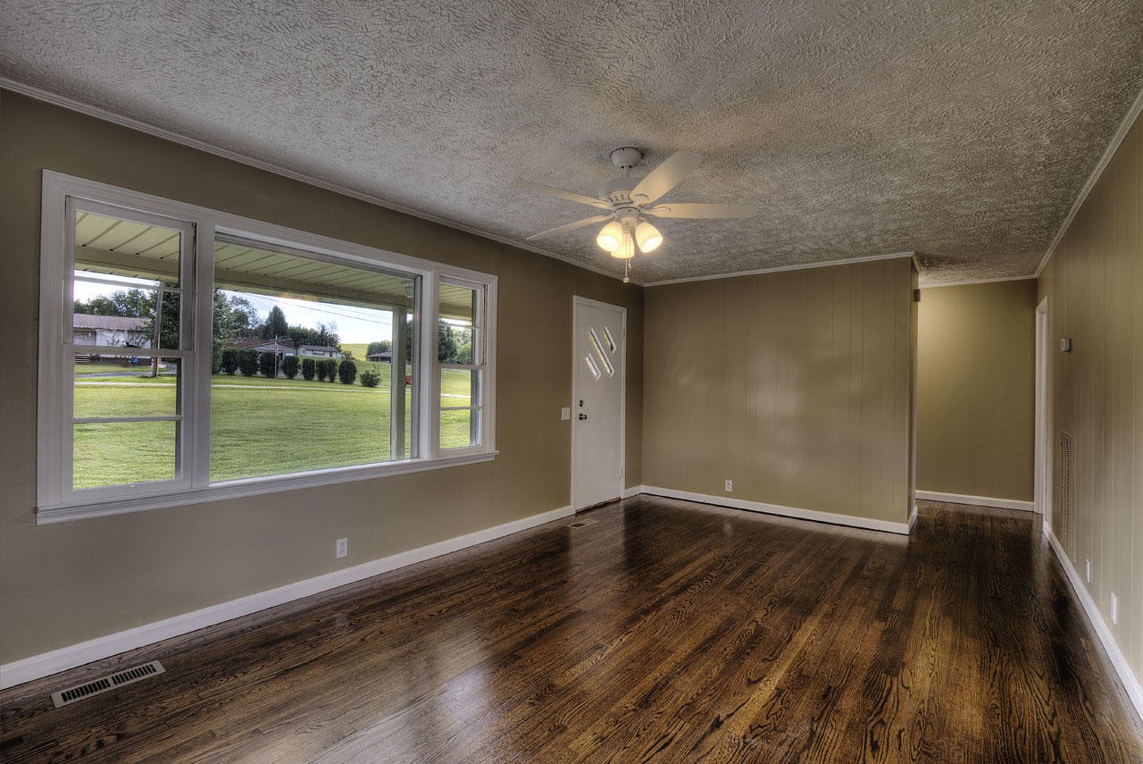 102 Stephens Road Greenback, TN 37742 - Photo 3 of 31 a view of an empty room with wooden floor and a window